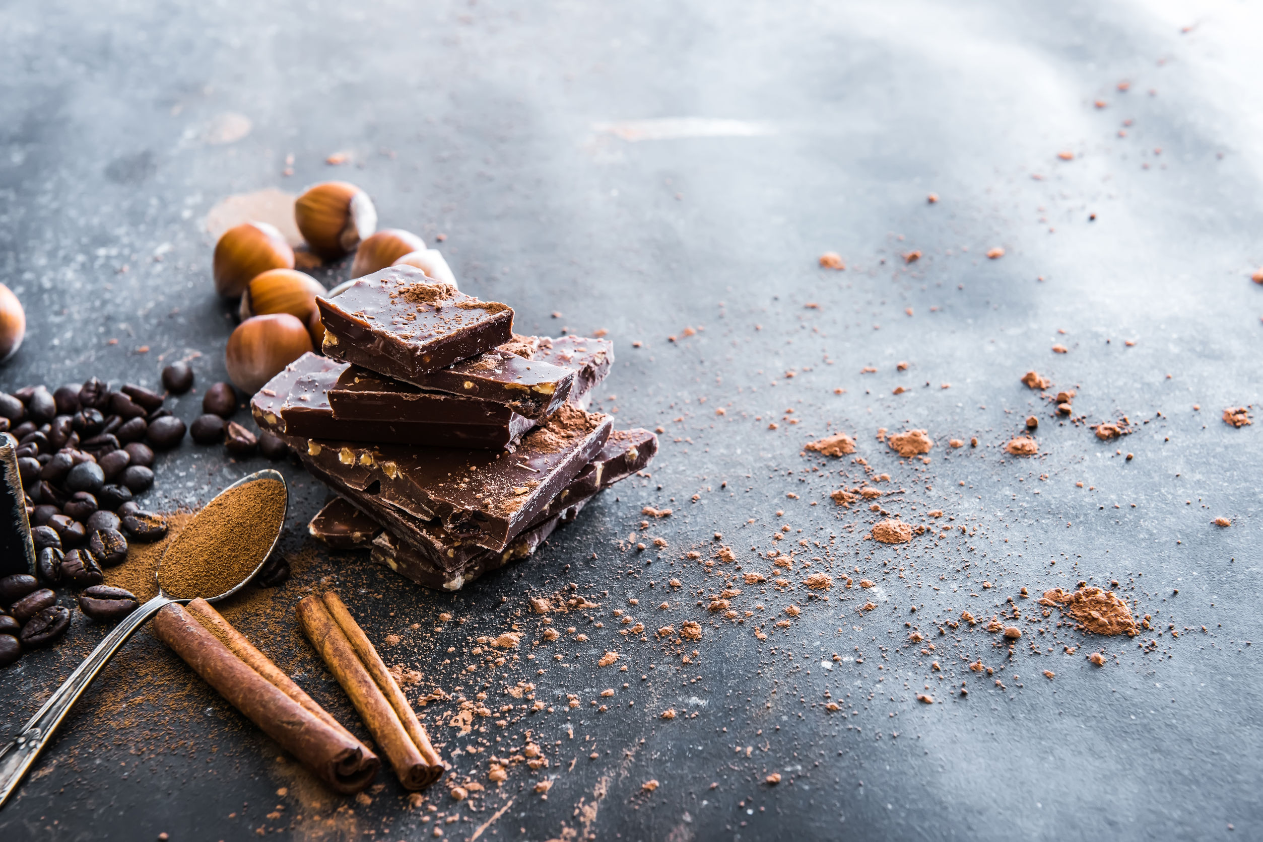 45364919 – chocolate, nuts, spices on a smooth black table