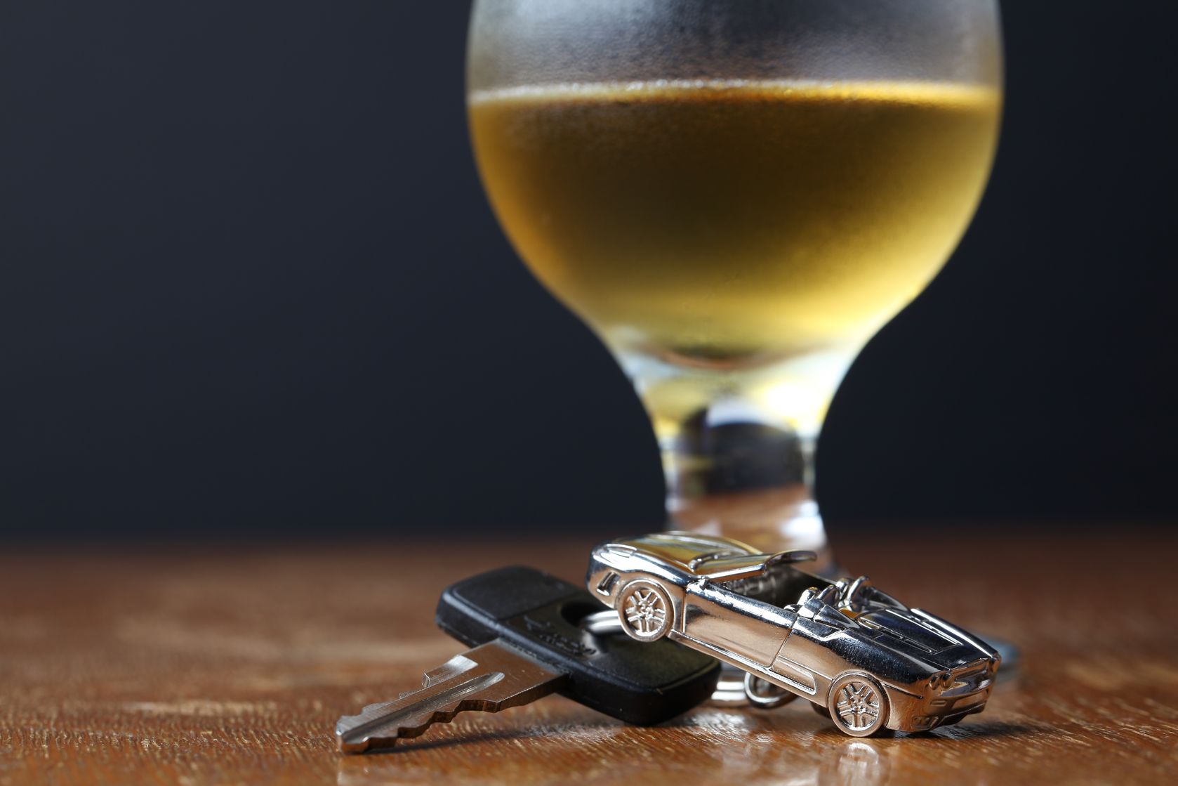 8229382 – car key with car-shaped pendant and a glass of beer